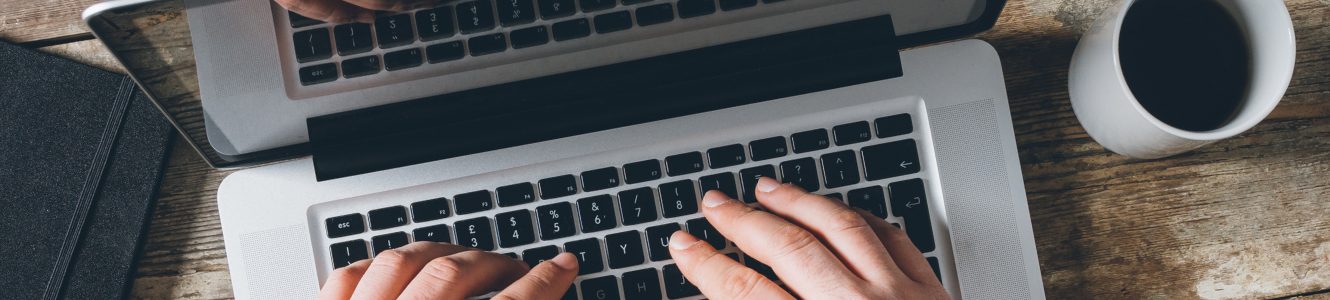 hands typing on computer