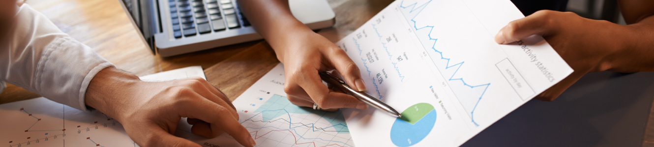 A close up of a woman pointing at charts