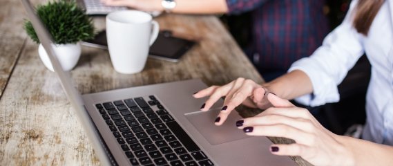 A woman typing on a laptop